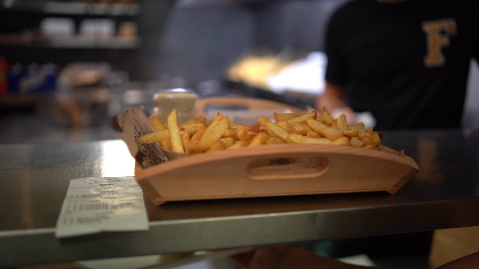 Une barquette de frites sur le comptoir de La Fratrie